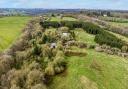 Farmhouse and useful buildings set in approximately 26 acres of pasture and woodland in Crediton, Devon.