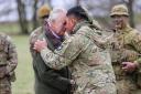 King Charles III receives the hongi - the traditional Maori greeting - from a New Zealander who is part of the Ukrainian contingent, during a visit to a training site for Ukrainian military recruits, in Wiltshire