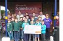 6th Devizes Scout group and Sainsburys staff with the cheque for £5801.45