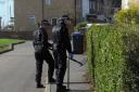 Police search hedges and gardens opposite Trowbridge Hospital today. Picture by Trevor Porter