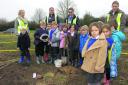 St George’s Primary pupils with Charlie, Flo and Vivien with the oak sapling they planted at the new Jubilee Wood at Littlemarsh