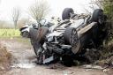 The black Range Rover which overturned in the collision that left a mother and her sons fighting for their lives