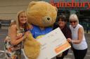 Sainsbury's manager Jan Mallender and ambassador Mo Bently hand over a cheque for £11,000 to  Big Ted  and Forever Friends' Bev Viveash. Picture by Trevor Porter