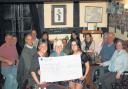 Landlady Julie Elliot, left, and daughter Alex Elliot, right, give a cheque to Help for Heroes volunteer Liz Bailey