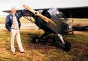 Jim Stoodley with a wartime aircraft like the one he flew when he was 13 in a bid to kill Adolf Hitler
