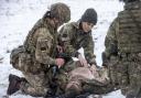 The Princess of Wales, Colonel of the Irish Guards, is shown how to carry out battlefield casualty drills to deliver care to injured soldiers during a casualty simulation exercise, during her first visit to the 1st Battalion Irish Guards since becoming