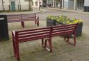 The Trowbridge town centre benches  - once black, now maroon-coloured.