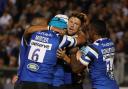 Bath's Rhys Priestland is mobbed as he celebrates scoring opening try against the Exeter Chiefs