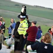 2014 Wiltshire Chief Constable trys on a hat at the Avebury Summer Solstice Photo  Diane Vose.