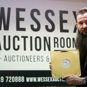Martin Hughes of Wessex Auction Rooms with the rare Beatles record, up for sale on April 22.