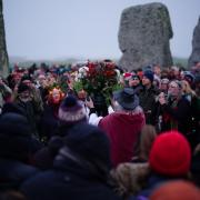 People take part in the winter solstice celebrations during sunrise at the Stonehenge prehistoric monument on Salisbury Plain in Wiltshire. Picture date: Thursday December 22, 2022.
