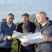 Cllrs David Vigar and Graham Hill with Martin Valatin pour over evidence of a Roman villa complex at Southwick Court Fields.