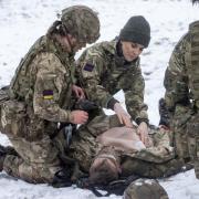 The Princess of Wales, Colonel of the Irish Guards, is shown how to carry out battlefield casualty drills to deliver care to injured soldiers during a casualty simulation exercise, during her first visit to the 1st Battalion Irish Guards since becoming