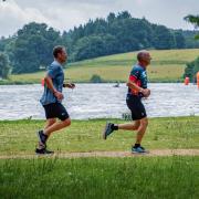 Runners passing the lake in the Bowood House Triathlon.
