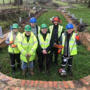 Wilts & Berks Canal Trust Branch chairman Dave Maloney (third from right) with work party volunteers in the dry dock being restored at Pewsham Locks.