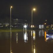 The scene at midnight on the Bradford Road and Brook Road  roundabout with cars stuck in the flood water.