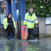 Environment Agency officials check businesses affected by the floods in Bradford on Avo