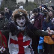 Watched by a record crowd, St George, played by Chris Born, of the Widcombe Mummers, goes into action at the Tithe Barn.
