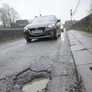 Drivers have to swerve to avoid the huge pothole on Bradford on Avon town bridge.