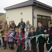 Pupils join Trowbridge Mayor Cllr Stephen Cooper to cut the ribbon opening the Roost a Net Zero extension to Castle Mead Primary School.