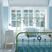 The colour combination of the lime green metal bed, sky blue walls and white floor boards makes the room appear fresh and young. From Living with Light: Decorating the Scandinavian Way by Gail Abbott, published by CICO Books, priced 20