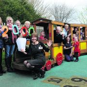 Westbury League of Friends representatives Sheila Stafford, Erica Watson, Kathryn Cundick, Shirley Baker and treasurer Peter Baker in the driving seat, with Stepping Stones manager Debbie Wickham, staff and pupils