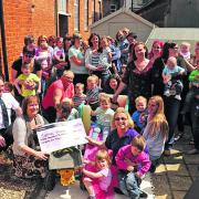 Jane Wickham of Sally Tots, centre front, hands over the cheque to Stepping Stones co-ordinator Barbara Jensen