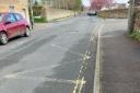 The faded road markings on Station Road are putting children's lives at risk, a councillor has claimed