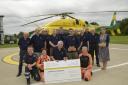 Chairman Phil Lobb and members of the Kennet & Avon Woodturners Club present WAA pilot George Williams and  critical care paramedics Emma Thompson and Jo Gilbert with cheque for £505.