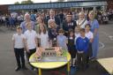 School head Vicki Cottrell with pupils cut the cake made identical to the new Coronation Building with Lord Lieutenant Mrs Sarah Troughton, Cllr Dominic Muns, Trowbridge Deputy Mayor Cllr Denise Bates and guests at the official opening.