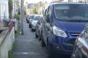 A row of cars parked on the pavements at West Street Trowbridge