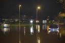 The scene at midnight on the Bradford Road and Brook Road  roundabout with cars stuck in the flood water.