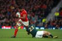Wales' Taulupe Faletau (left) looks to break through the tackle of South Africa's Jan Serfontein during the Rugby World Cup game at Twickenham Stadium, London..