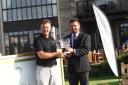 Cumberwell Park director of golf John Jacobs presents the trophy to Sion Bebb (right)