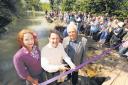 Duncan Hames cuts the ribbon to open the newly restored Wilts & Berks Canal, with Rebecca Lamont Jiggens, grant programme manager of Community First and Trust chairman John Laverick