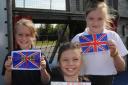 The Mead Primary School pupil Emily with her Go Britain Go flag and school mates Isabelle and Katie with Union flags made to welcome the Tour of Britain. Picture by Trevor Porter