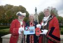 Town Crier Trevor Heeks selects a poppy for the Mayor Cllr Graham Hill from poppy seller Marion Oliver who has been involved with the selling of poppies for 35 years. Photo: Trevor Porter 69365-1