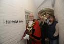 Trowbridge Mayor Cllr Stephen Cooper cuts the tape to officially open the Hardwick Suite, together with people that made it possible.