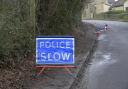 Police flashing lights warn motorists of the potholes on the A363 Bath Road just outside Bradford on Avon