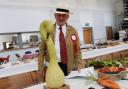 Show co-odinator John Potter takes a close look at the outstanding squash looking like a swan.