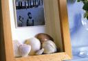 A glass fronted box frame with a holiday shot and shells collected from the beach, from 101 Finishing Touches.
