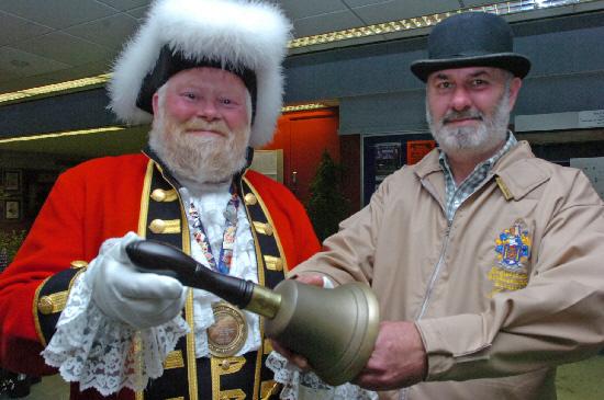 Trevor Heeks receives his renovated bell from wood turner John Aitken. Photo: Trevor Porter