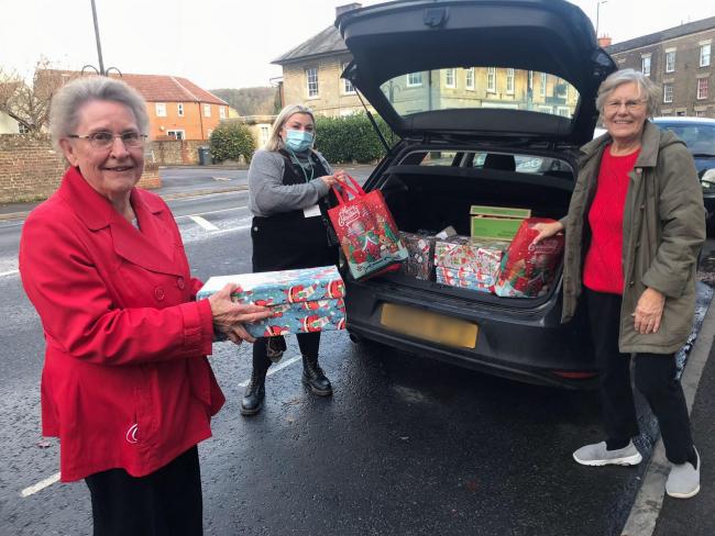 Brenda and Joan from United Church, Warminster helping Megan Hayward, Refugee Support Officer for Wiltshire Council load the shoeboxes into the car