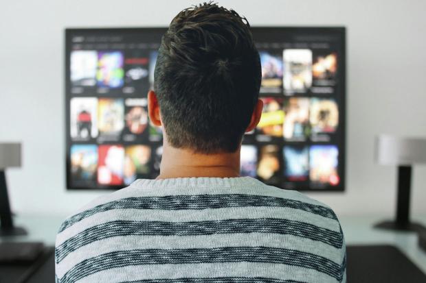 Wiltshire Times: A man watching a smart TV. Credit: Canva