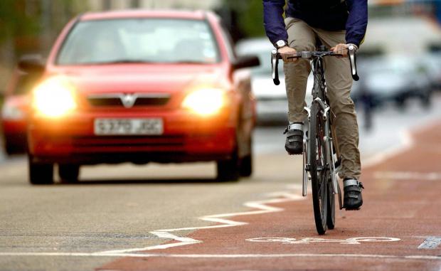 Wiltshire Times: Photo via PA shows a cyclist on the road near traffic.