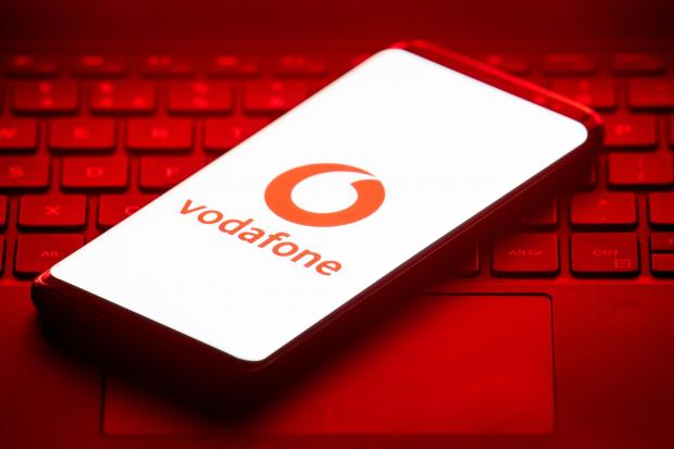 Wiltshire Times: Vodafone logo on a phone placed on a keyboard. Credit: PA