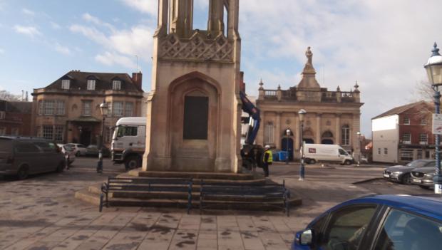 Wiltshire Times: The Market Cross bearing the warning plaque.