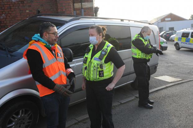 Wiltshire Times: Picket supervisor Nick Day, left, with police at the Hills depot at Trowbridge today