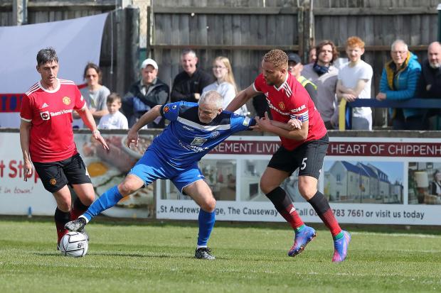 Chippenham Town goalscorer Steve Tweddle holds off Manchester United legend Wes Brown during last weekend’s friendly at the Thornbury Surfacing Stadium               Photo: Richard Chappell