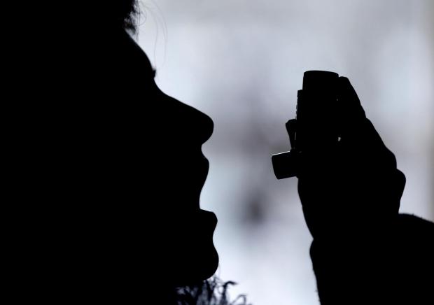 Wiltshire Times: Silhouette of a person using an inhaler. Credit: Canva